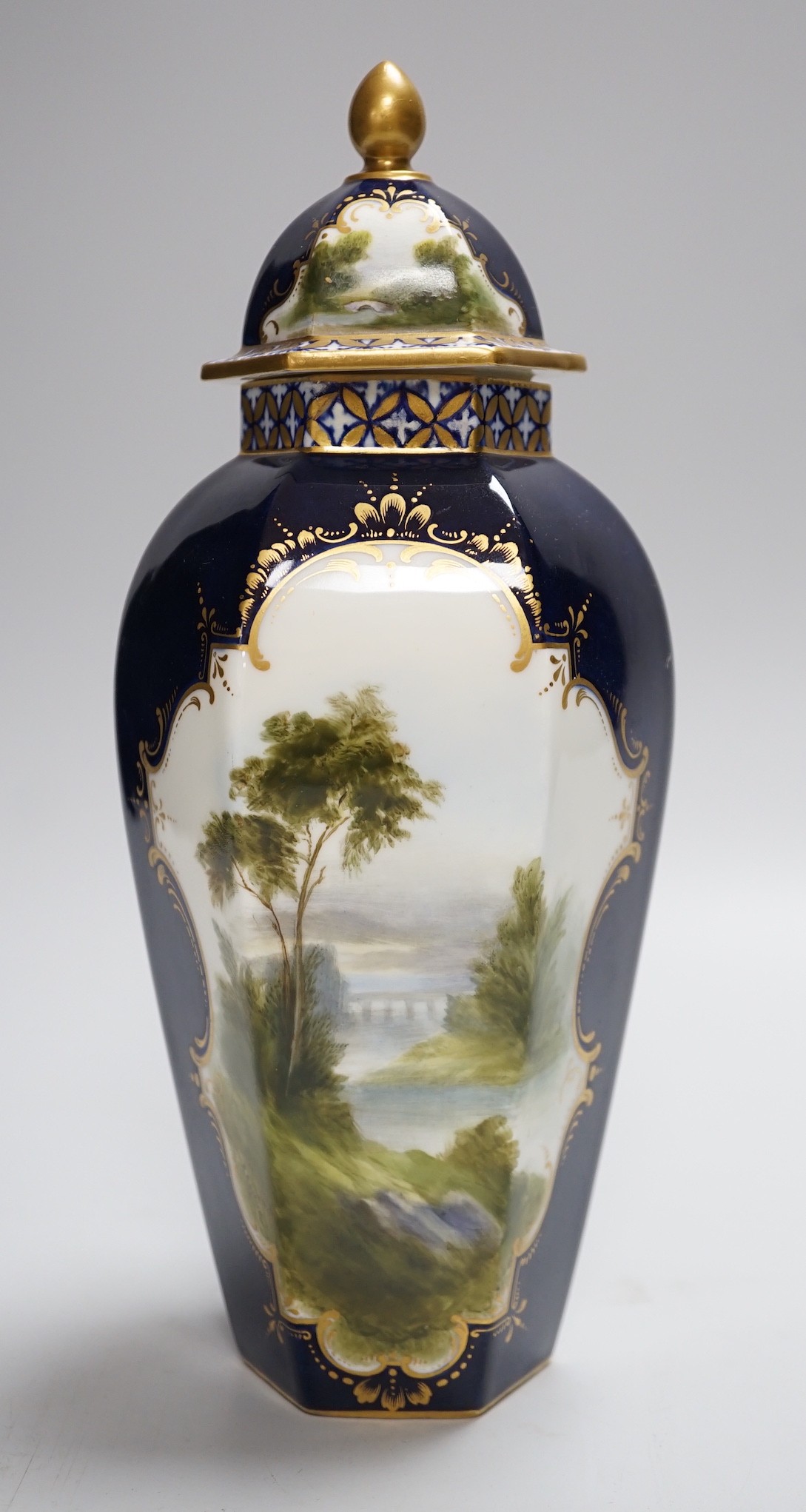 A Royal Worcester landscape painted hexagonal vase and cover signed R.Rushton, 24cm